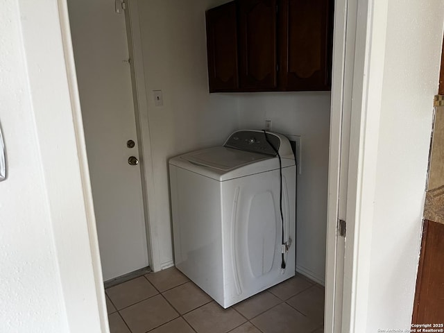 washroom featuring cabinets, washer / dryer, and light tile patterned floors