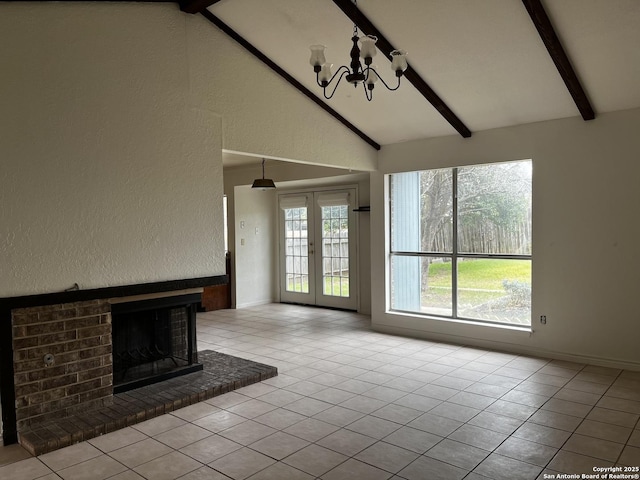 unfurnished living room with french doors, a fireplace, lofted ceiling with beams, a chandelier, and light tile patterned flooring