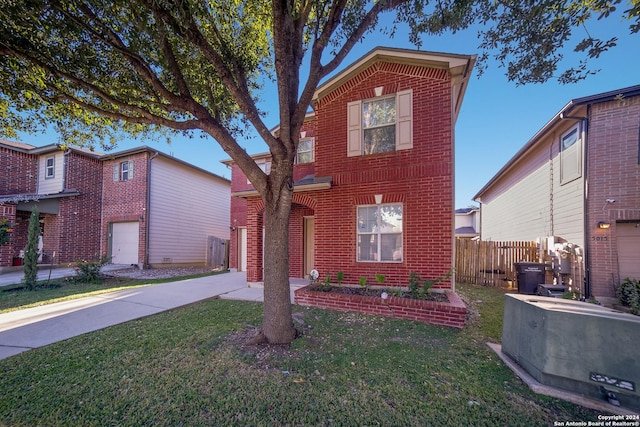 front facade with a front lawn and a garage