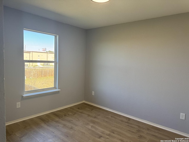 spare room featuring hardwood / wood-style floors