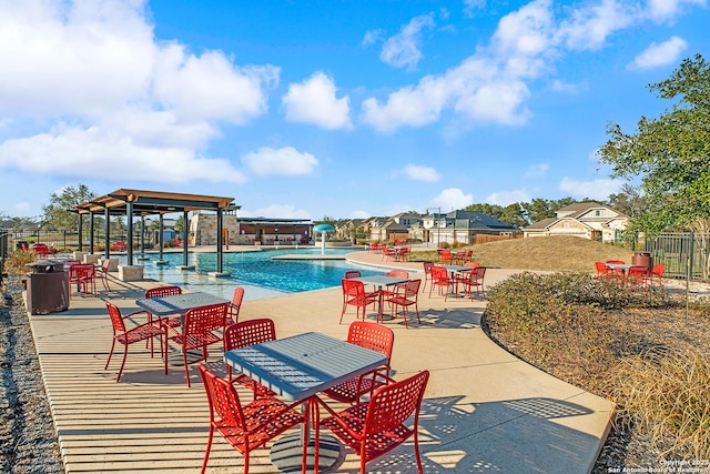 view of swimming pool with pool water feature and a patio