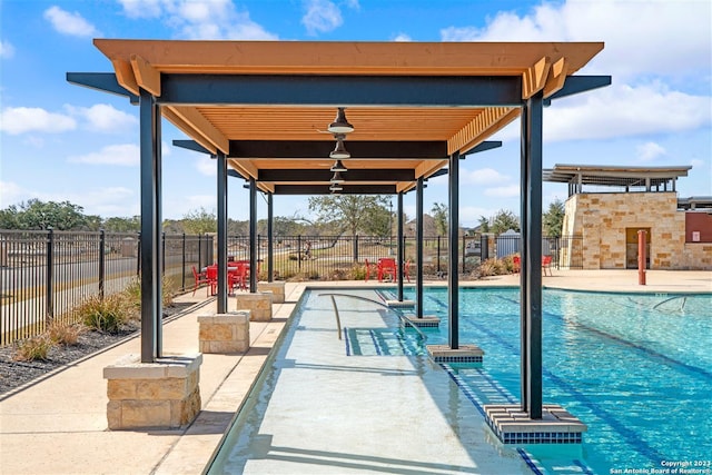 view of swimming pool featuring a patio area and a fireplace