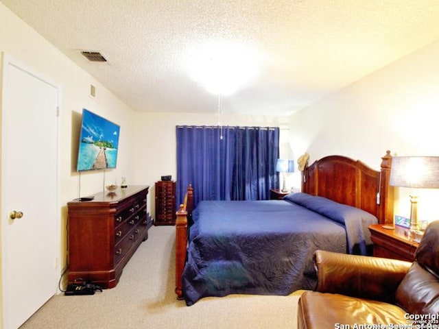 carpeted bedroom with a textured ceiling