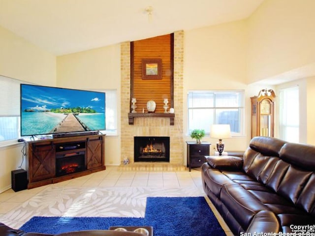 tiled living room featuring high vaulted ceiling, a brick fireplace, and a healthy amount of sunlight