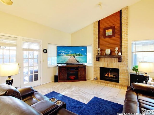 living room with a brick fireplace, light tile patterned floors, vaulted ceiling, and a wealth of natural light