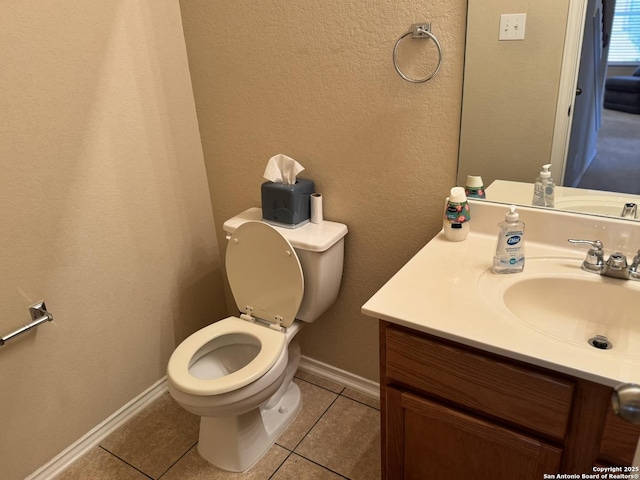 bathroom featuring toilet, vanity, and tile patterned floors