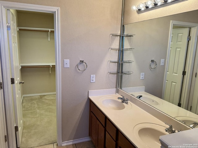 bathroom featuring tile patterned flooring and vanity