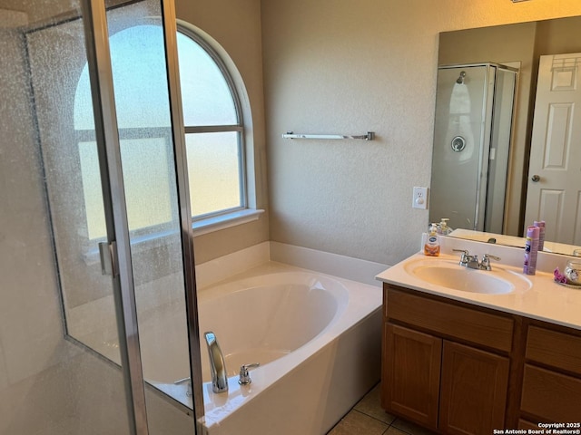 bathroom featuring tile patterned floors, vanity, and shower with separate bathtub