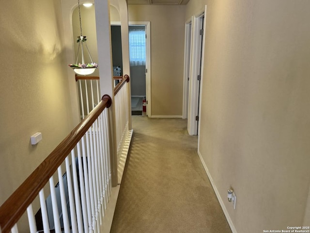 hallway with light colored carpet