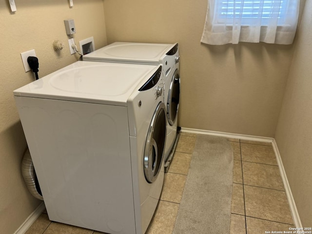 washroom with washer and dryer and light tile patterned flooring