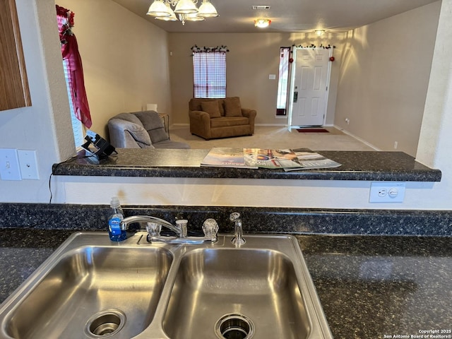 kitchen with carpet floors and sink