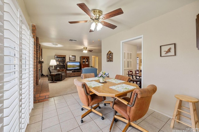 dining space with ceiling fan and light tile patterned floors