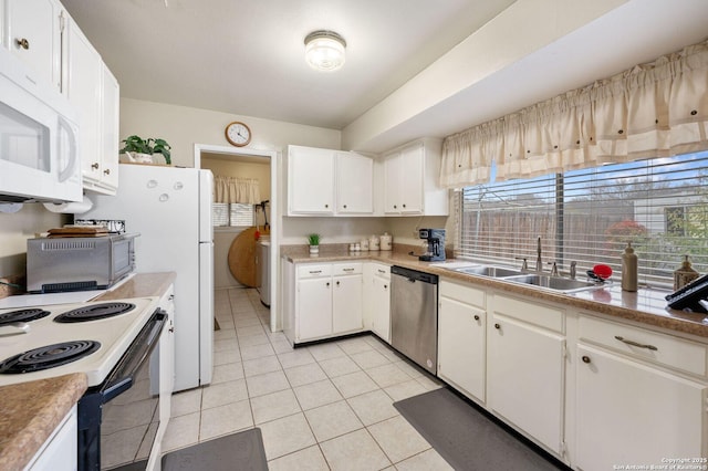 kitchen featuring sink, white appliances, white cabinetry, and light tile patterned flooring