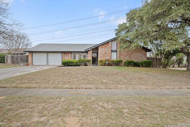 ranch-style house featuring a front yard and a garage