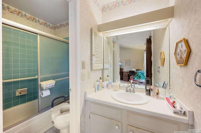 full bathroom with toilet, vanity, and shower / bath combination with glass door