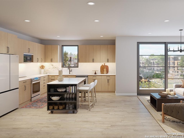 kitchen featuring light brown cabinets, white refrigerator, decorative light fixtures, stainless steel range with electric stovetop, and light wood-type flooring