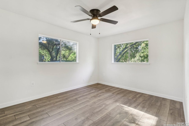 empty room featuring ceiling fan and light wood-type flooring