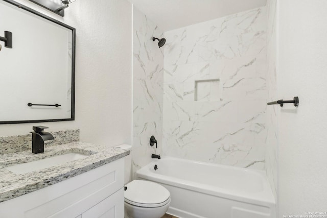 full bathroom featuring vanity, toilet, and tiled shower / bath