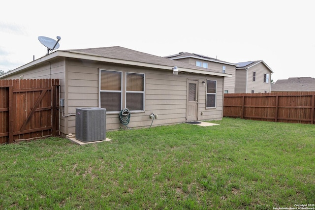 11726 Deer Ml, San Antonio, TX 78254 - rear view of house featuring a lawn, central AC unit, and a fenced backyard