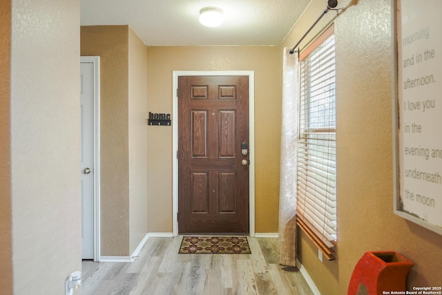 entrance foyer featuring a textured ceiling and light hardwood / wood-style flooring