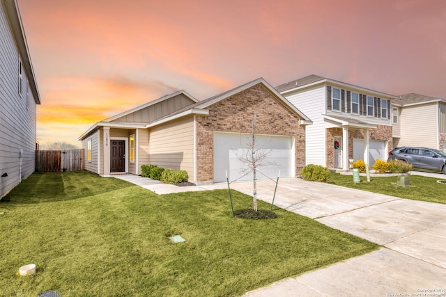 view of front of house featuring a garage and a lawn