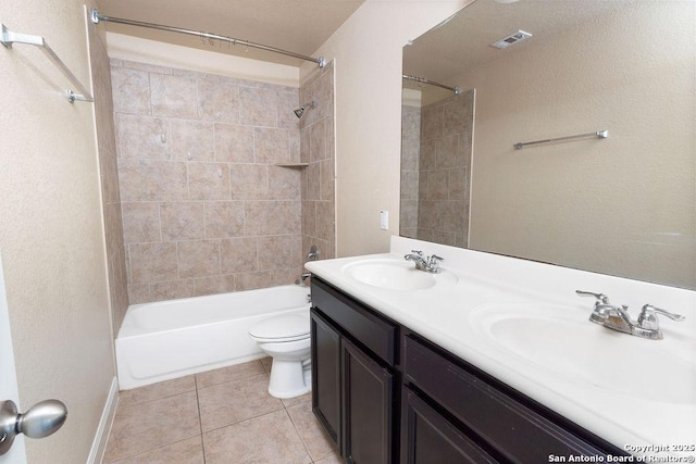 full bathroom with tile patterned flooring, vanity, toilet, and tiled shower / bath