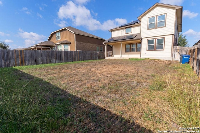 rear view of property with a yard and a patio