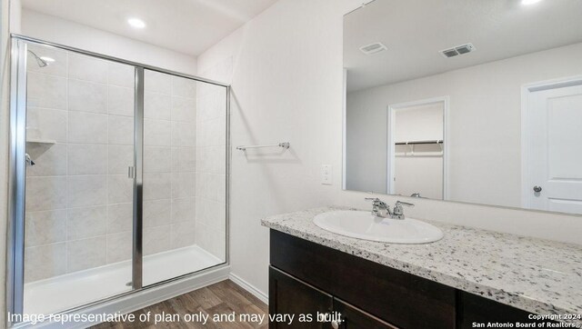 3216 Pemberton Rose, San Antonio, TX 78245 - bathroom with vanity, an enclosed shower, and wood-type flooring