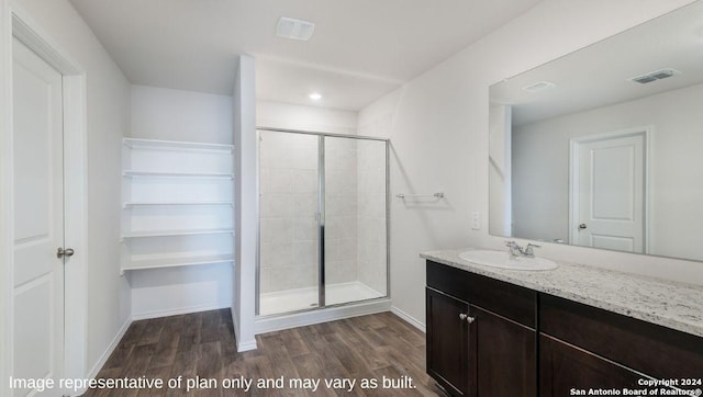 3216 Pemberton Rose, San Antonio, TX 78245 - bathroom featuring wood-type flooring, vanity, and a shower with shower door