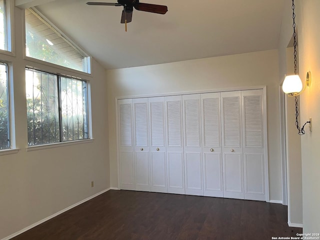 unfurnished bedroom featuring vaulted ceiling with beams, ceiling fan, a closet, and dark wood-type flooring