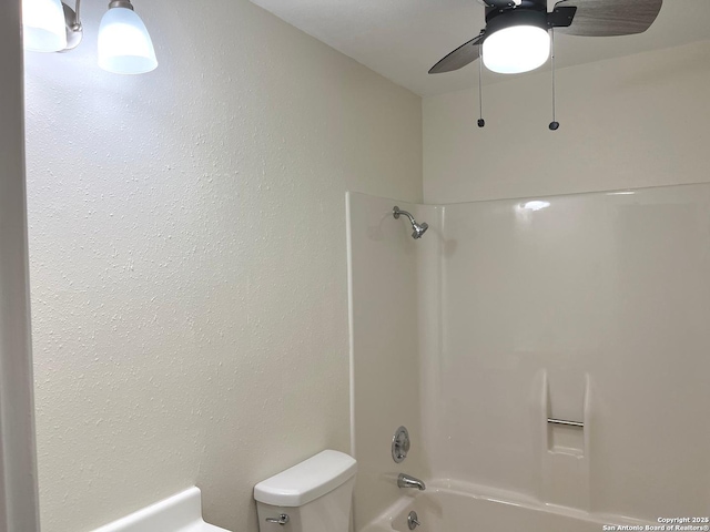 bathroom featuring ceiling fan, shower / bath combination, and toilet