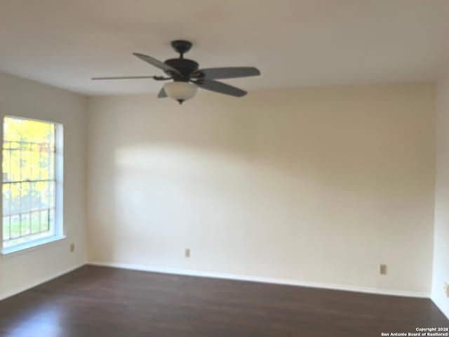 spare room featuring ceiling fan and dark hardwood / wood-style flooring