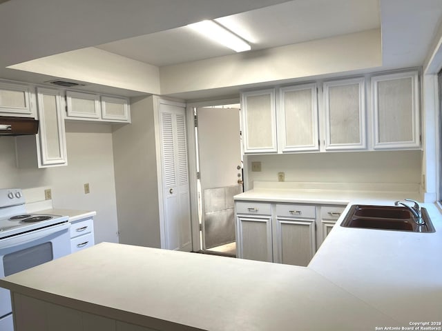 kitchen featuring white electric range and sink