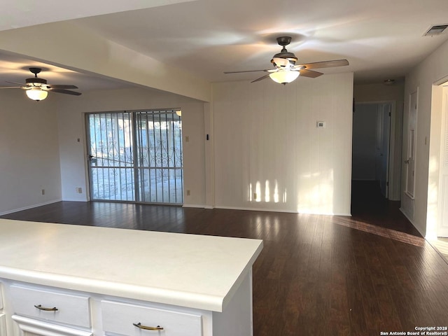 kitchen featuring ceiling fan and dark wood-type flooring