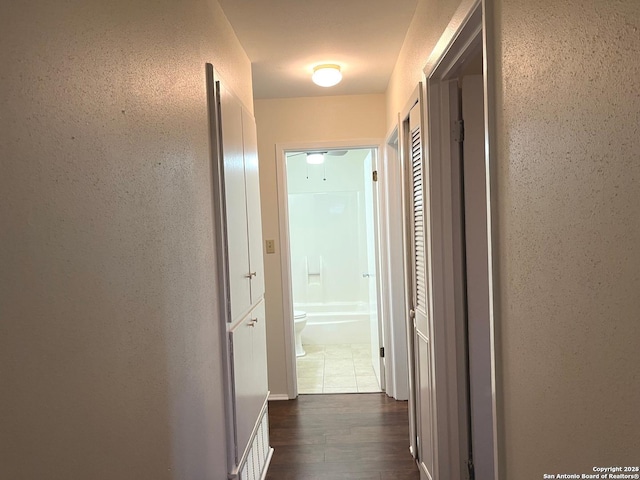 hallway with dark hardwood / wood-style floors