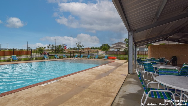 view of swimming pool with a patio