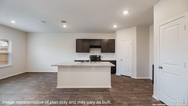 kitchen featuring black range with electric stovetop, dark brown cabinets, an island with sink, and dark hardwood / wood-style floors