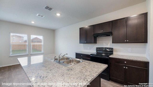 kitchen featuring sink, black range with electric cooktop, light hardwood / wood-style flooring, a kitchen island with sink, and dark brown cabinets