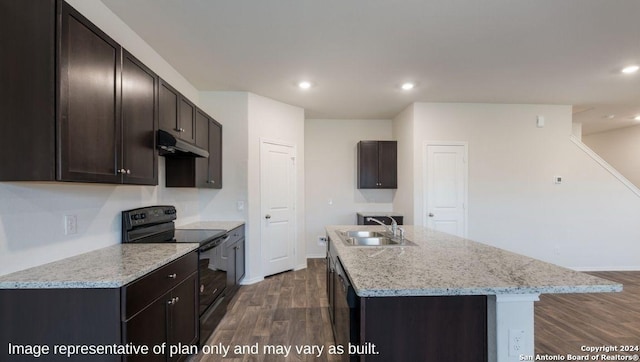 kitchen with a kitchen island with sink, black appliances, sink, dark hardwood / wood-style floors, and dark brown cabinetry