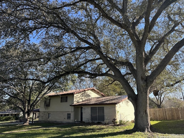 view of side of home featuring a yard