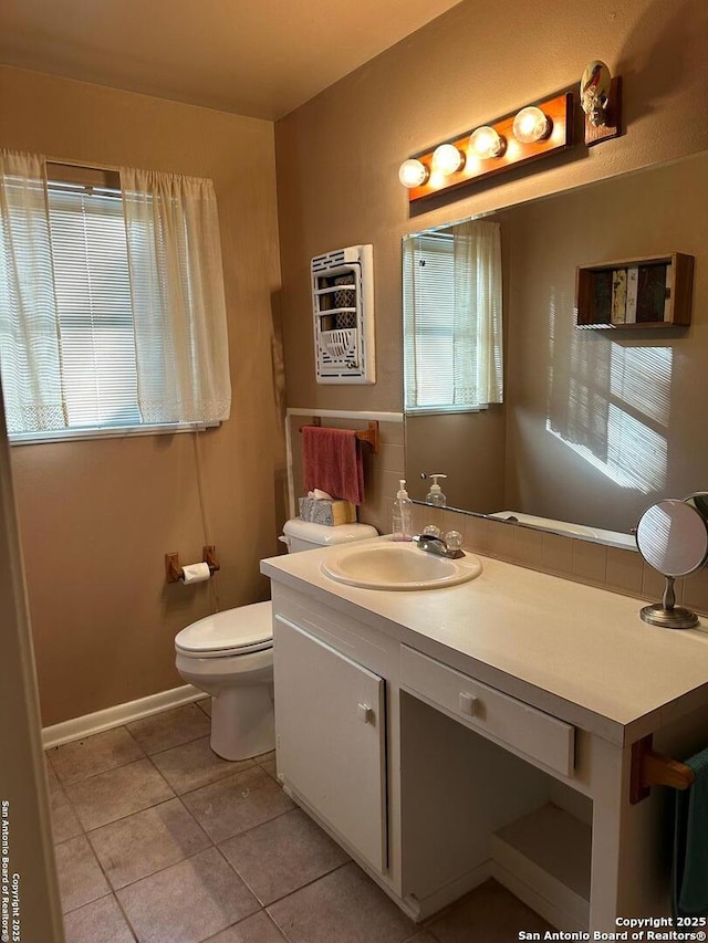 bathroom featuring tile patterned floors, plenty of natural light, vanity, and toilet