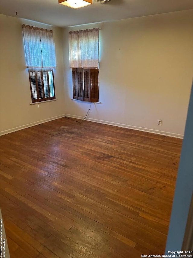 spare room featuring dark hardwood / wood-style floors