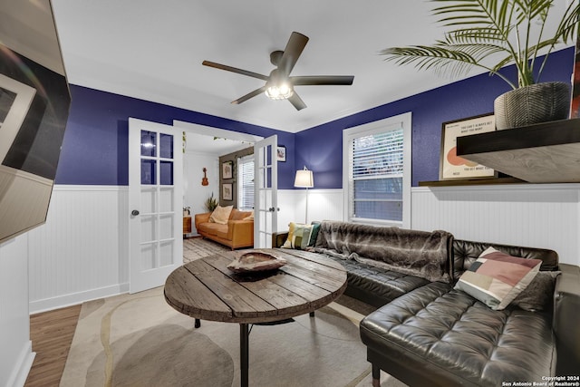 living room featuring ceiling fan, french doors, hardwood / wood-style floors, and ornamental molding