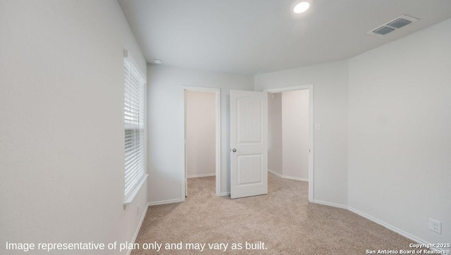 interior space with light colored carpet and a wealth of natural light