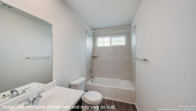 full bathroom with tiled shower / bath combo, toilet, wood-type flooring, and vanity