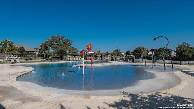 view of swimming pool with fence