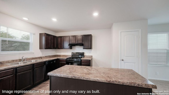 kitchen with recessed lighting, dark brown cabinetry, a sink, under cabinet range hood, and black appliances