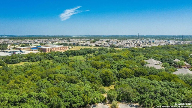 birds eye view of property with a wooded view