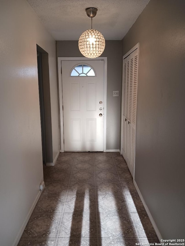 entryway with a textured ceiling