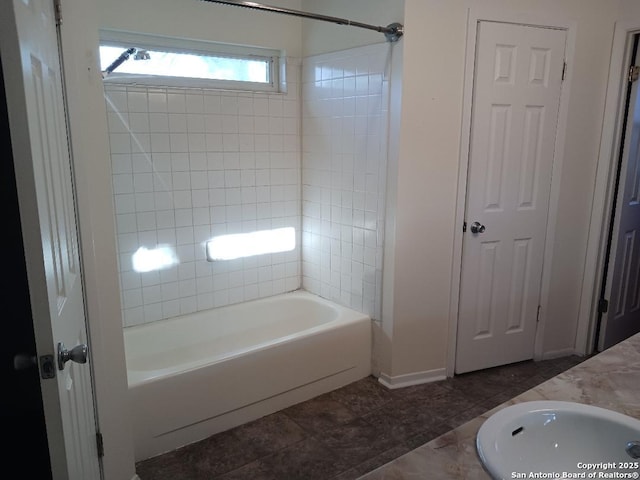 bathroom featuring vanity, tile patterned flooring, and tiled shower / bath combo